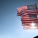 multiple american flags in the sky