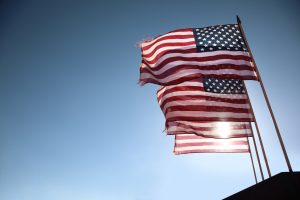 multiple american flags in the sky