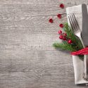 rustic holiday place setting with pine bough and berries_308860889