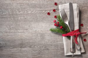 rustic holiday place setting with pine bough and berries_308860889