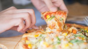 Pizza Slice in Hands