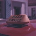 Car with Pizza Service Sign