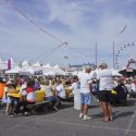 large group of people gathered around picnic tables at Springfest in OCMD